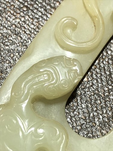Lot 116 - A Chinese carved celadon jade plaque on a...