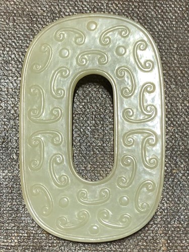 Lot 116 - A Chinese carved celadon jade plaque on a...