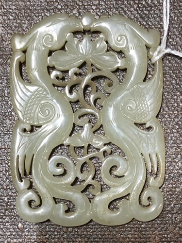 Lot 116 - A Chinese carved celadon jade plaque on a...