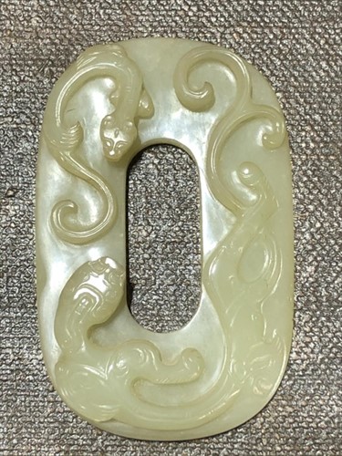 Lot 116 - A Chinese carved celadon jade plaque on a...