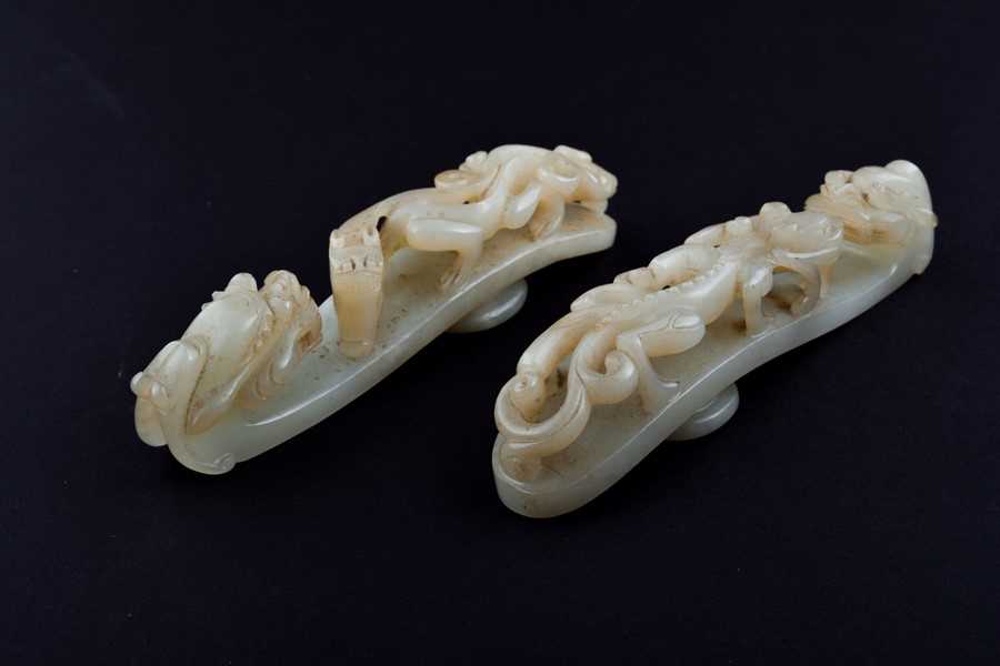 Lot 120 - Two Chinese celadon jade belt buckles each...