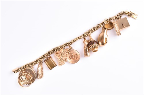 Lot 470 - A gilt metal curb-link charm bracelet...