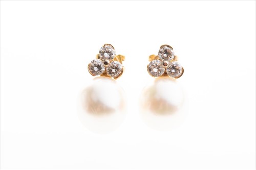 Lot 474 - A pair of diamond and pearl earrings each set...