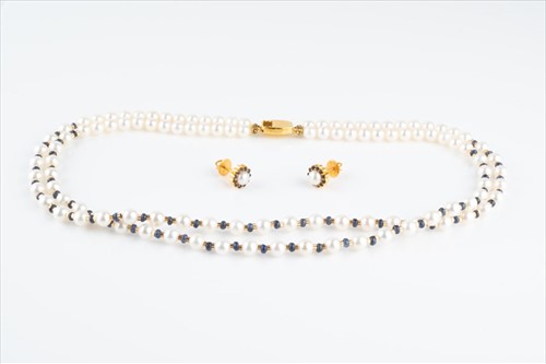 Lot 541 - A double strand pearl and sapphire beaded...