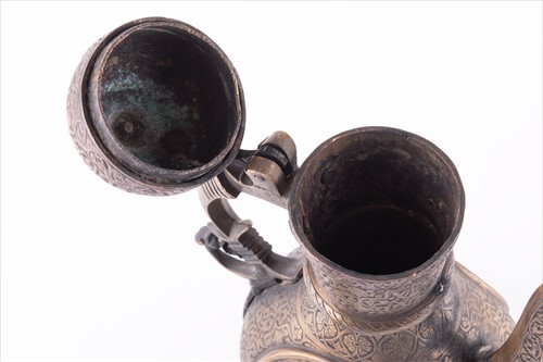 Lot 168 - A Middle Eastern damascene brass teapot...