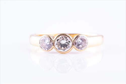 Lot 488 - An 18ct yellow gold and diamond ring bezel-set...