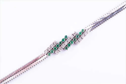 Lot 525 - An emerald and diamond bracelet set with...