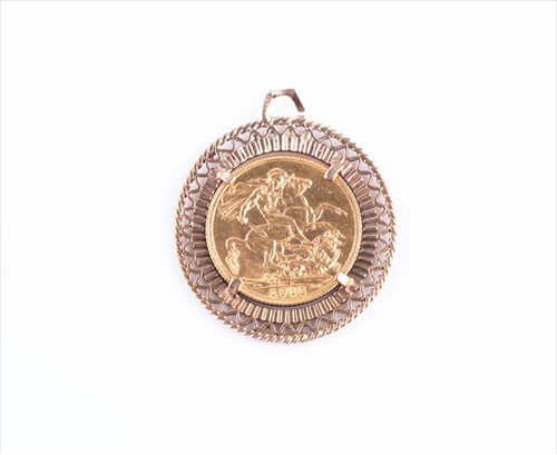 Lot 506 - A yellow metal and coin pendant set with a...