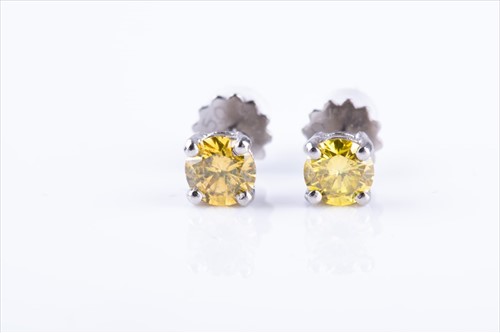 Lot 464 - A pair of fancy yellow diamond ear studs the...