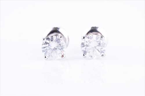 Lot 466 - A pair of solitaire diamond ear studs the...