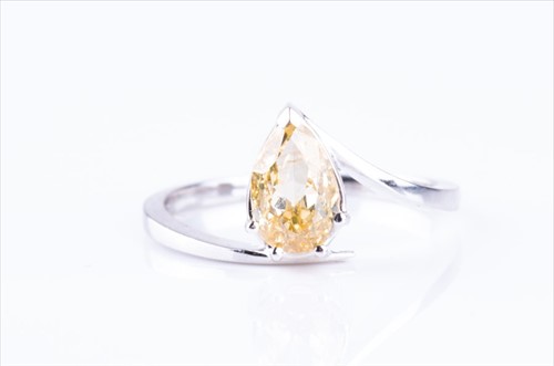 Lot 465 - A fancy yellow mixed pear-cut diamond ring of...