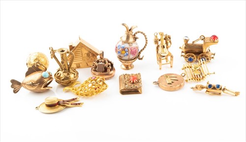 Lot 431 - Fourteen yellow metal (all test gold) charms,...