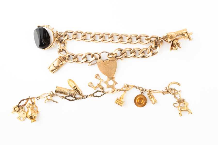 Lot 427 - A 9 carat gold charm bracelet suspended with...