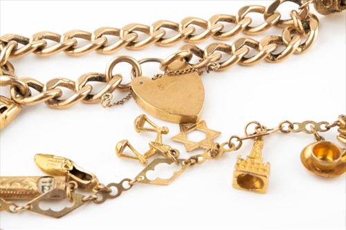 Lot 427 - A 9 carat gold charm bracelet suspended with...