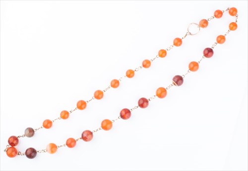 Lot 423 - A gilt metal and carnelian necklace formed of...