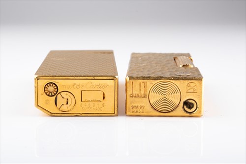 Lot 245 - A gold plated Cartier cigarette lighter and a...