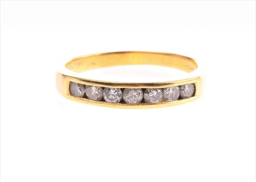 Lot 561 - An 18ct yellow gold half-eternity diamond ring...