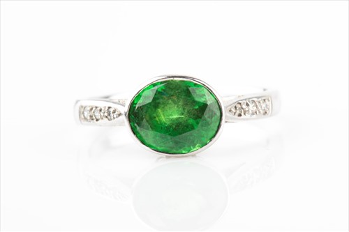 Lot 425 - A platinum, diamond, and tsavorite garnet ring...