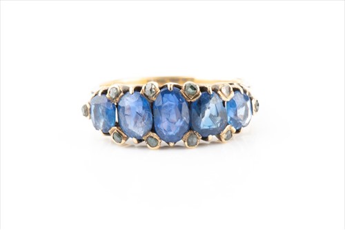 Lot 491 - A yellow metal, sapphire, and diamond ring set...