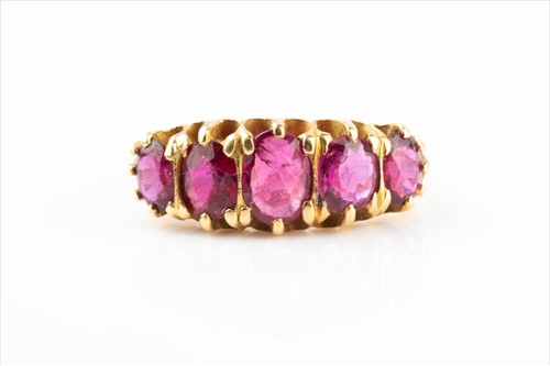 Lot 490 - A yellow metal and ruby ring set with five...