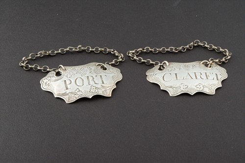 Lot 404 - A pair of George II silver decanter labels...