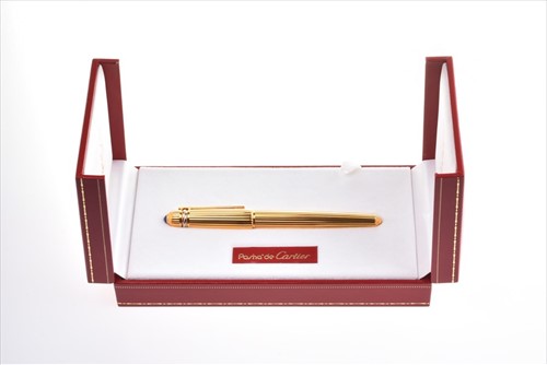 Lot 246 - Pasha de Cartier. A gold plated ball point pen...