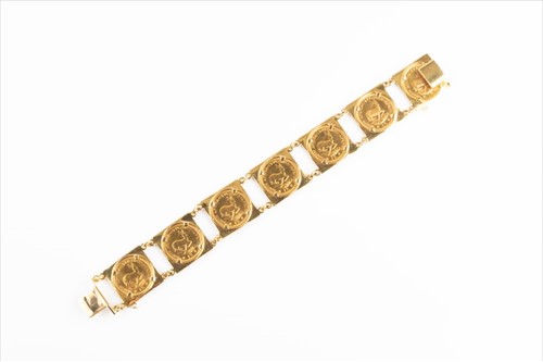 Lot 488 - A yellow metal coin bracelet inset with seven...