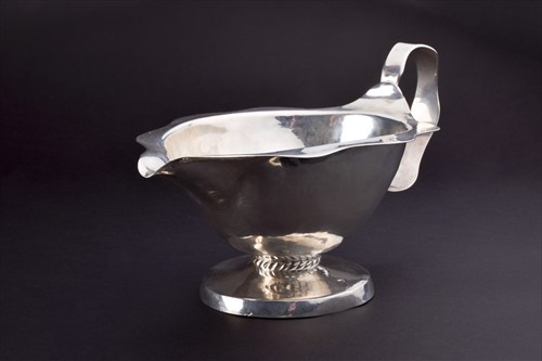 Lot 408 - A planished silver sauce boat with scalloped...