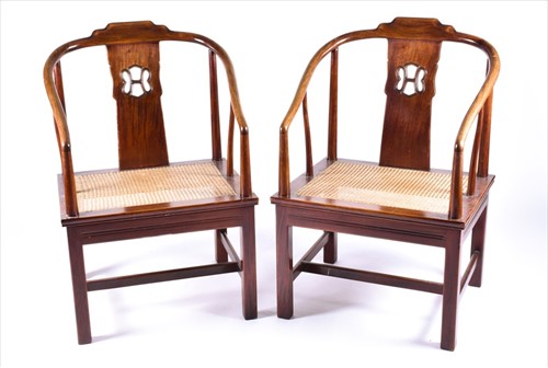 Lot 97 - A pair of Chinese softwood horseshoe elbow...