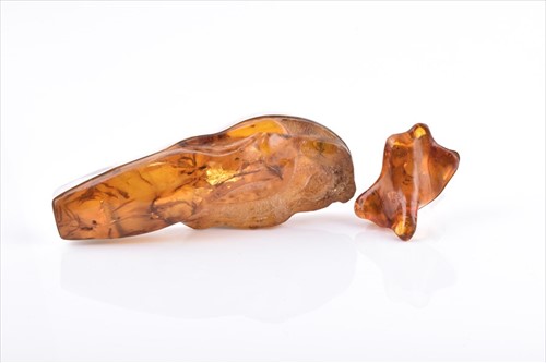 Lot 557 - An unusual silver and amber pendant set with a...