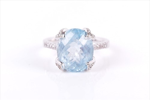Lot 717 - An 18ct white gold, diamond, and blue topaz...