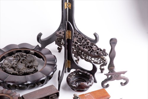 Lot 183 - A collection of Chinese carved hardwood stands...