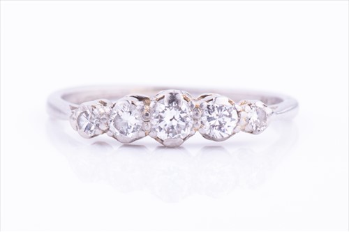 Lot 468 - A platinum and diamond ring set with five...