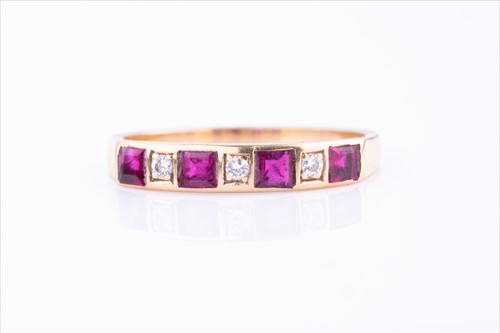 Lot 469 - A diamond and ruby half band ring set with...