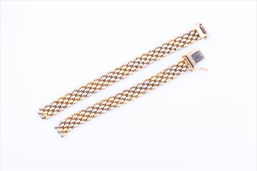Lot 551 - A yellow metal articulated mesh-link bracelet...