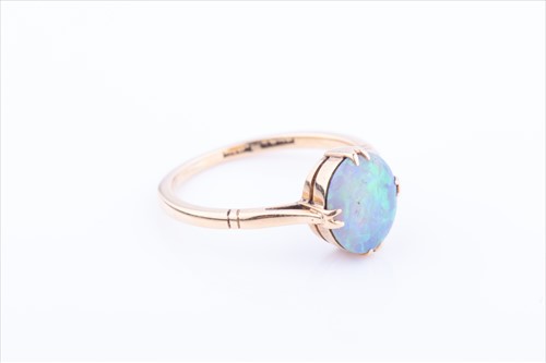 Lot 576 - An 18ct yellow gold and opal ring set with a...