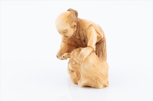Lot 158 - A Japanese ivory netsuke in the form of a...