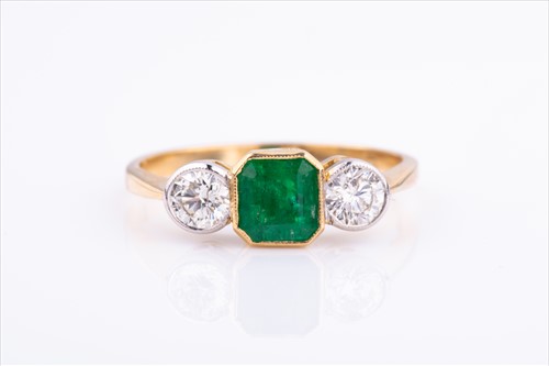 Lot 497 - An 18ct yellow gold, diamond, and emerald ring...