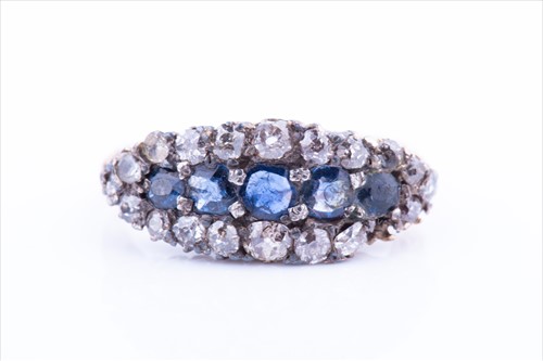 Lot 521 - A diamond and sapphire ring the bow-shaped...