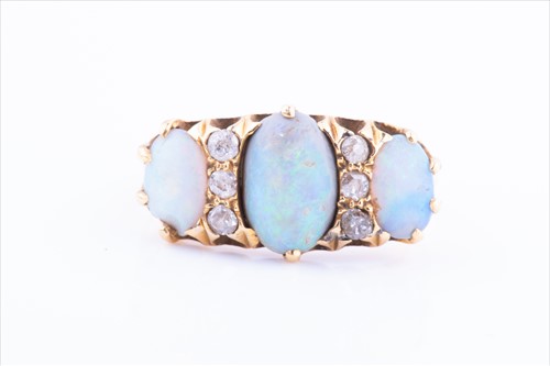 Lot 522 - An 18ct yellow gold, diamond, and opal ring...