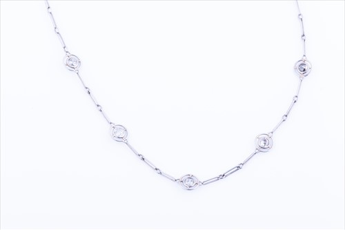 Lot 540 - A white metal and diamond chain necklace set...