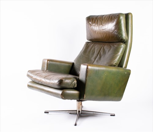 Lot 140 - A 1970s green leather upholstered armchair...