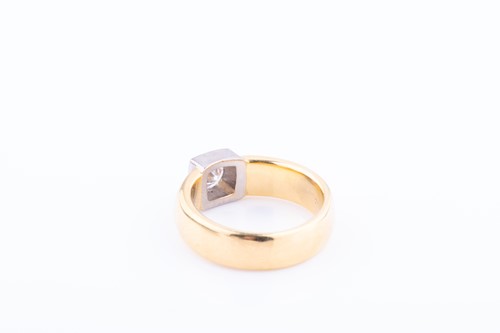 Lot 466 - A diamond solitaire ring in yellow and white...