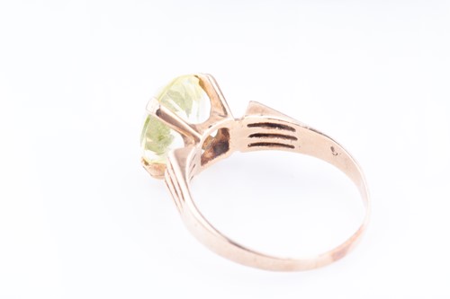 Lot 472 - A yellow metal and pale green gemstone ring...