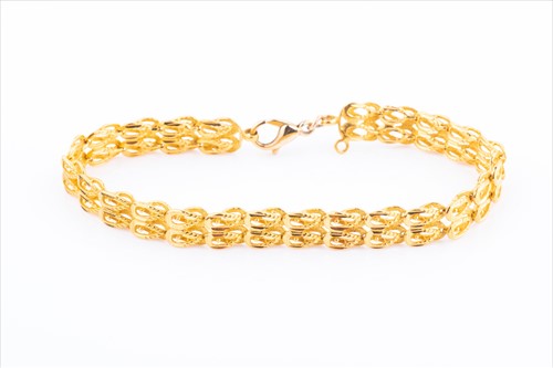 Lot 428 - A yellow metal fancy-link chain bracelet with...