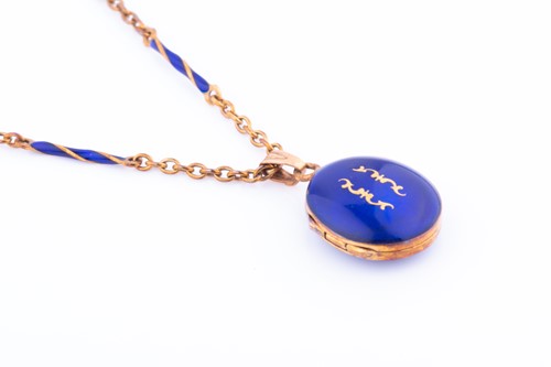 Lot 448 - A rose metal and blue enamel locket pendant...