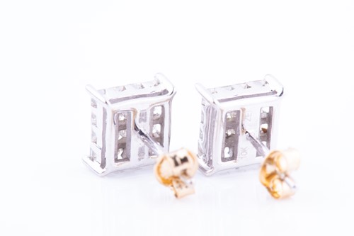 Lot 447 - A pair of white metal and diamond earrings of...