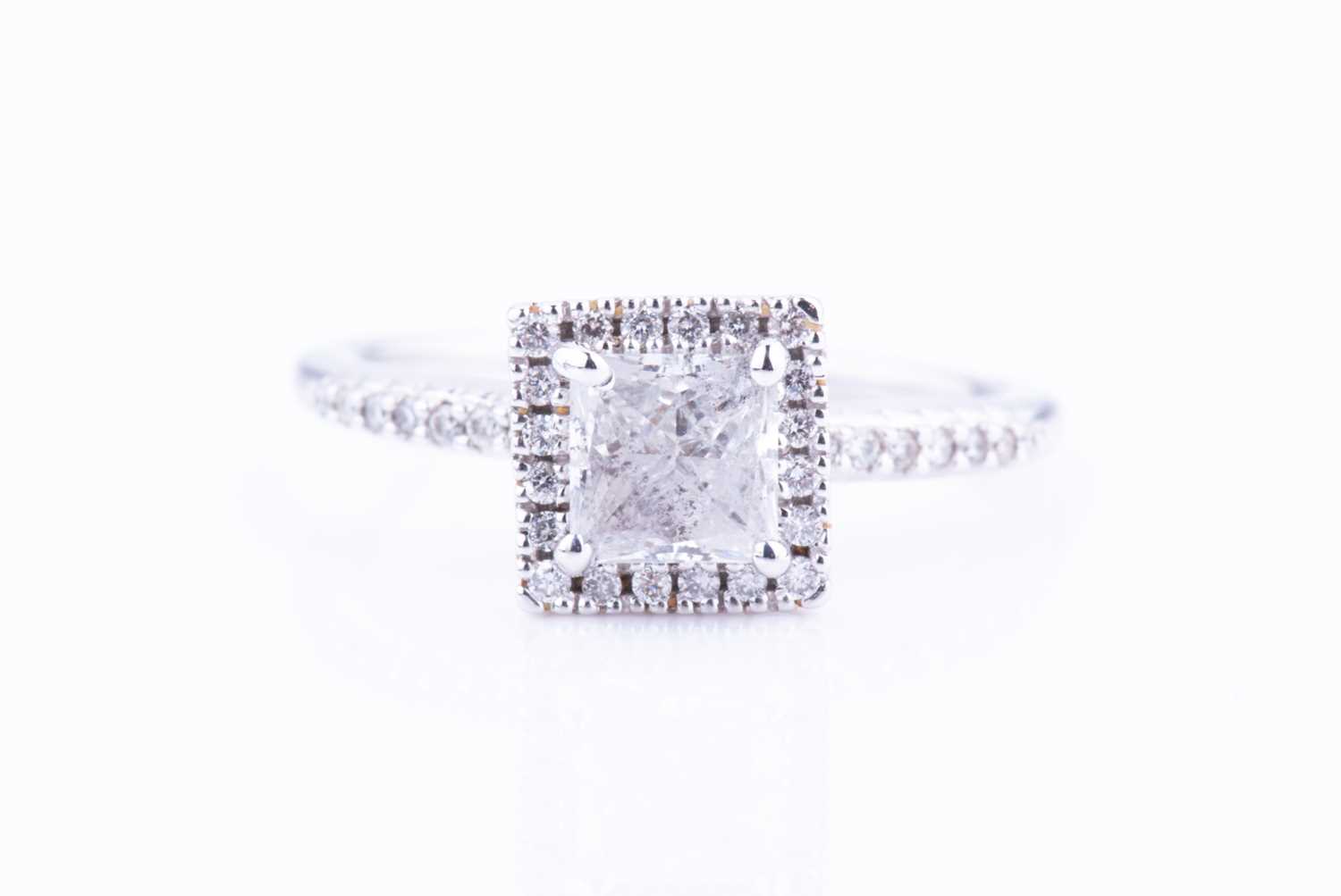 Lot 454 - A diamond cluster ring set with a princess-cut...