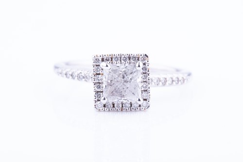 Lot 454 - A diamond cluster ring set with a princess-cut...