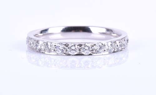 Lot 376 - A platinum and diamond eternity ring, inset...